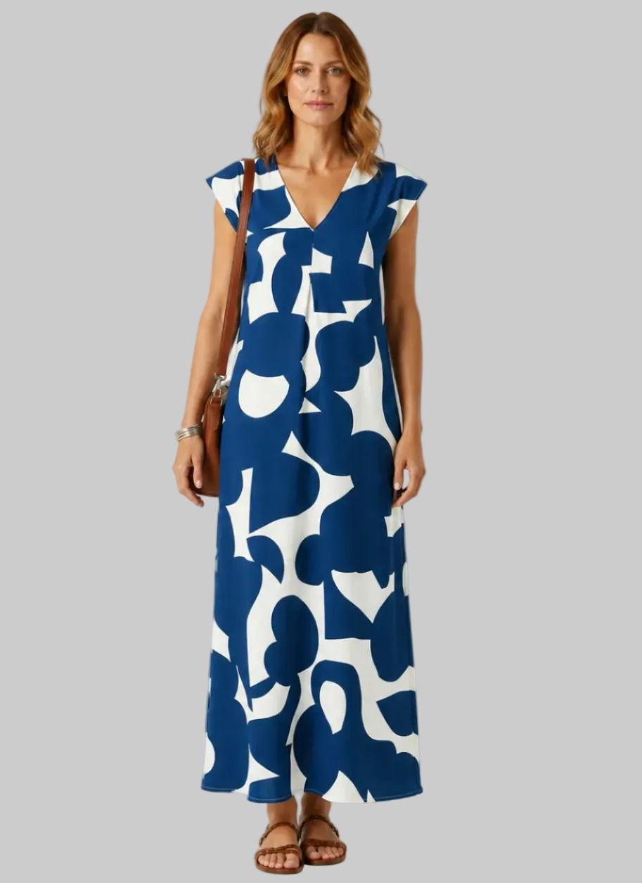 Woman wearing a blue and white patterned dress on a plain background