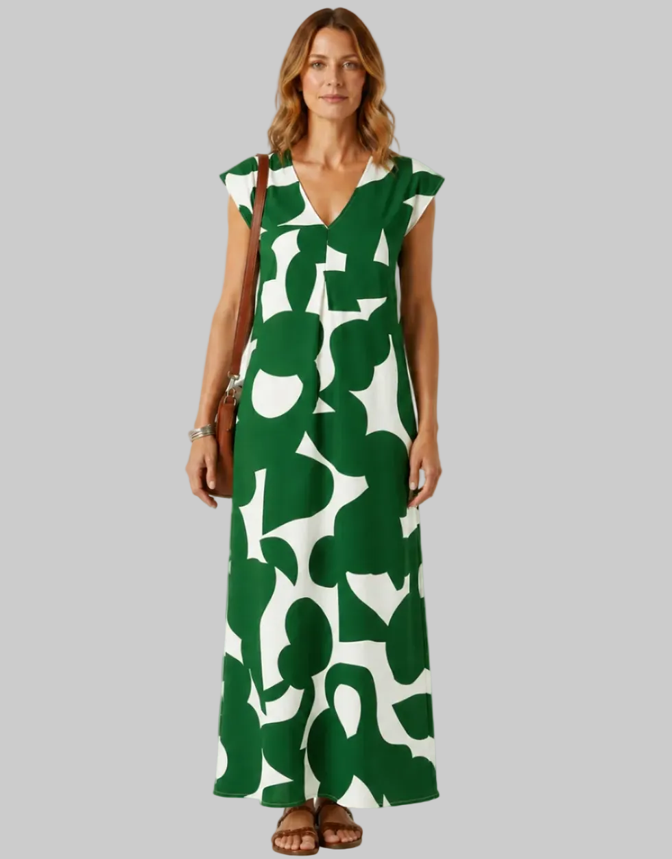 Woman wearing a green and white patterned dress on a white background